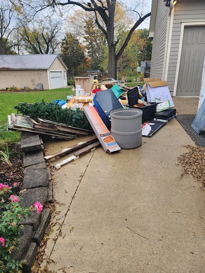 Dumpster being loaded with debris for Estate Cleanout Dumpster Rental in Decatur